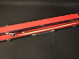 a red box with two wooden sticks in it