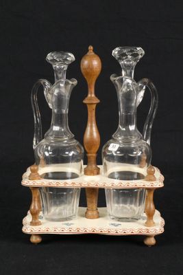 three glass vases and a wooden stand on a black background