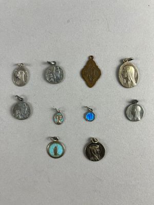 a close up of a bunch of different charms on a white surface