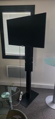 a flat screen tv sitting on a stand in a living room