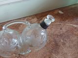 two empty bottles sitting on the floor next to a window