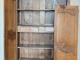 a wooden cabinet with a door open in a room