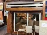 a bunk bed with a desk and a chair in the room