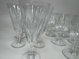 several empty wine glasses are lined up on a table