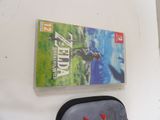 a nintendo wii game on the wall next to a backpack