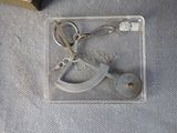 a keychain that has been placed in a plastic case