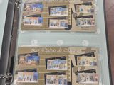 two folders with pictures of people on them on a table