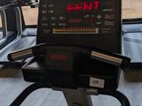 a view of a gym room with treads and a monitor