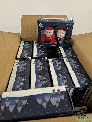 a cardboard box with a couple of christmas figurines inside of it