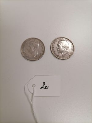 two coins are shown next to each other on a white surface