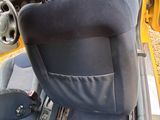 a picture of a seat in a car with the door open