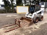 a picture of a small ski - door parked in a dirt lot