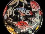 a glass ball with a design on it on a black background