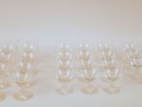 several empty wine glasses are lined up on a white surface
