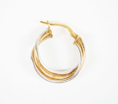a pair of gold and silver hoop earrings on a white background