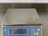 a digital scale sitting on a counter top in a kitchen