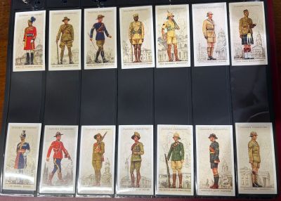 a lot of pictures of men in uniforms on a table