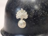 a close up of a helmet with a leaf on it