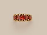 a gold ring with garnets and diamonds
