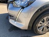the front end of a silver car with a denting dent on it