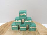 several boxes of tea bags stacked on top of each other on a wooden table