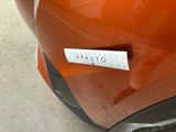 a sticker on the front of an orange car