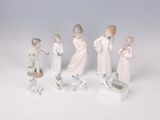 five figurines of people that are standing in a line