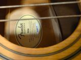 a close up of an acoustic guitar with a label on it