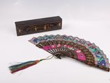 a fan and a box on a white surface