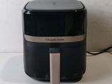 a black and silver air fryer sitting on a counter