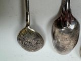 three spoons and a spoon rest on a table