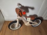 a small wooden bike with a saddle on the back
