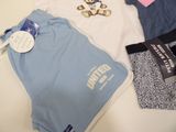 three pairs of underwear and a t - shirt laying on a table