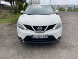 the front of a white nissan qx parked in a parking lot