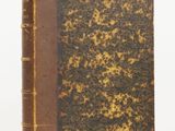 an old book sitting on top of a table next to a white background