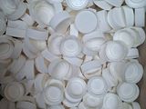 a cardboard box filled with white plastic cups and lids