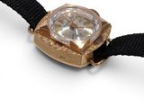 a gold watch with a black strap on a white surface