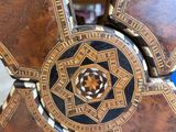 a close up of a wooden table with a decorative design on it