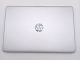 hp laptop computer sitting on top of a white table with a logo on it