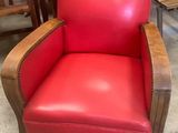 une chaise rouge qui se trouve au milieu d'une pièce