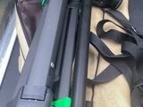 two tripods and a bag on the seat of a bus