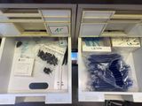two open drawers with electronic components in them