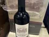 une bouteille de vin posée sur un comptoir à côté d'un colis