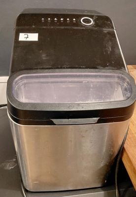 an image of a silver and black ice maker on a counter