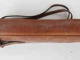 an image of a brown leather purse on a white surface