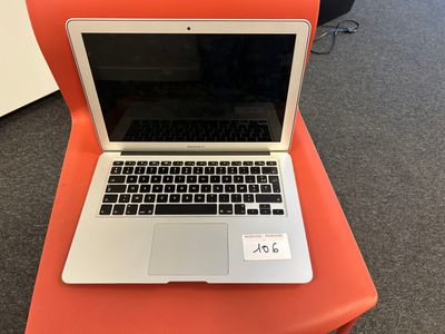 an orange chair with a laptop sitting on top of it