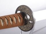 a close up of a sword with a metal handle