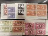 three different stamps from different countries are on display in a glass case