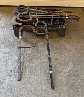 a pile of tools sitting on the floor next to a wall