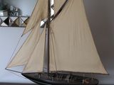 a sailboat on a table with a mirror in the background